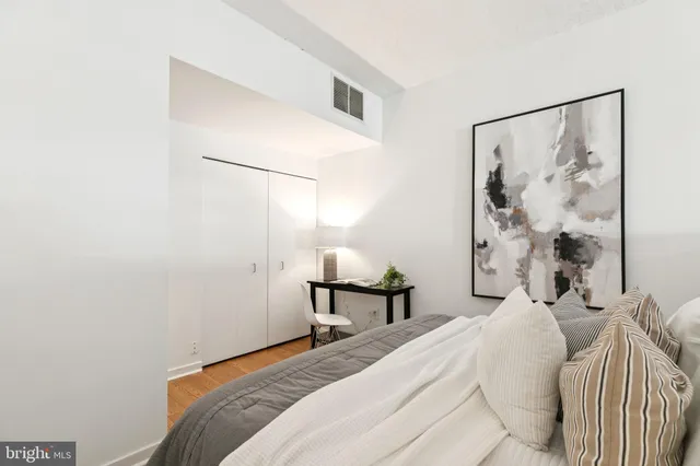 a bedroom with a bed and a table in it