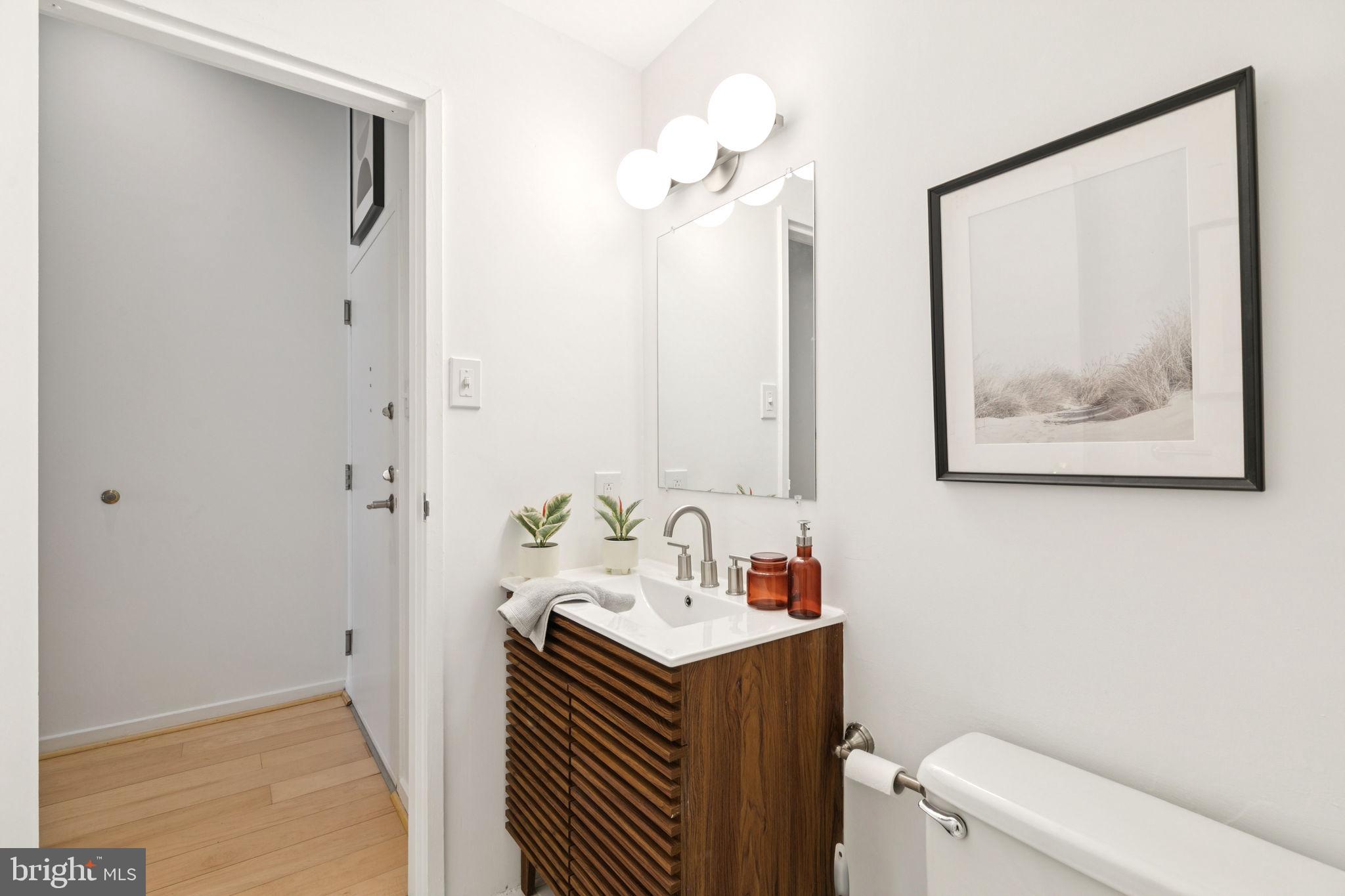 2429 Locust Street, Unit 318 Philadelphia, PA 19103 - Photo 18 of 35 a bathroom with a sink vanity and a mirror