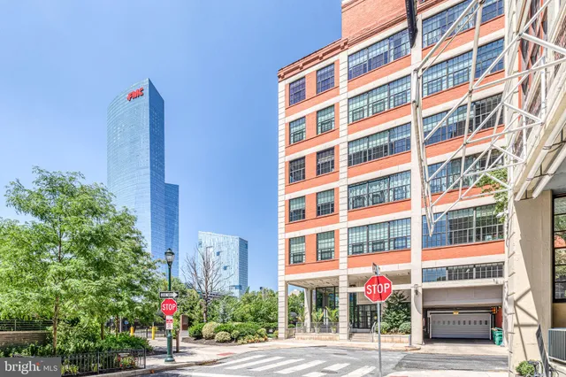 a front view of a multi story building with yard