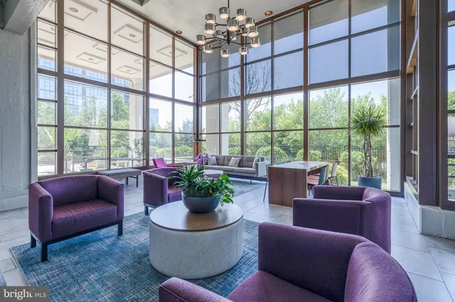 a living room with furniture a flat screen tv and large window