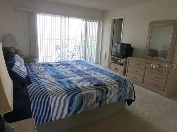 a bedroom with a bed and a television in it