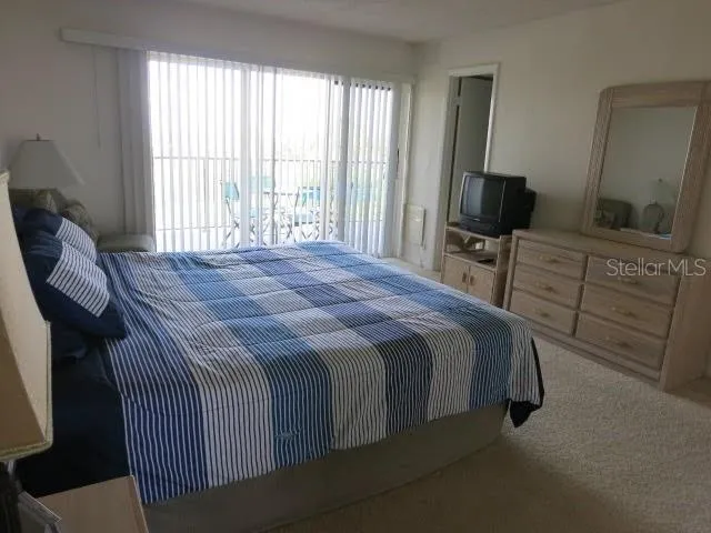 a bedroom with a bed and a television in it