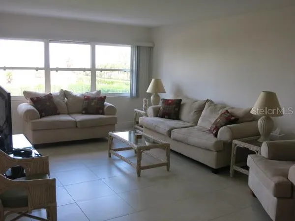 a living room with furniture and a large window