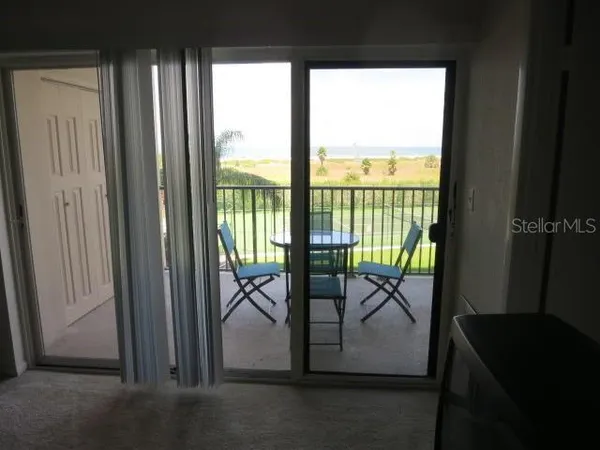 a view of a room with yard from balcony