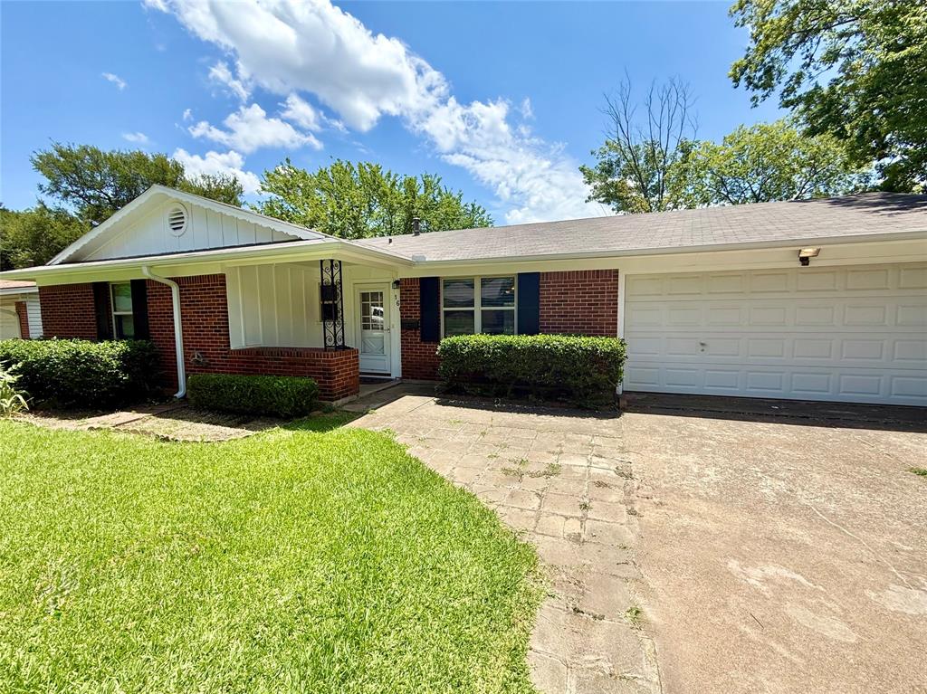 160 Bob White Road Denison, TX 75020 - Photo 2 of 29 Brick exterior with white trim, featuring a two-car garage, mature landscaping, and an inviting front entrance