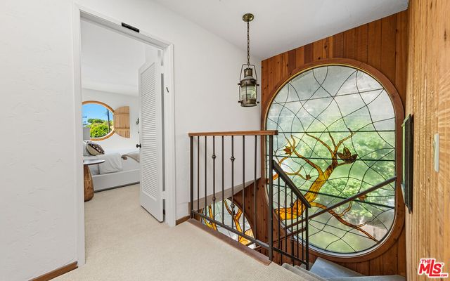 a balcony with wooden floor outdoor seating and ocean view