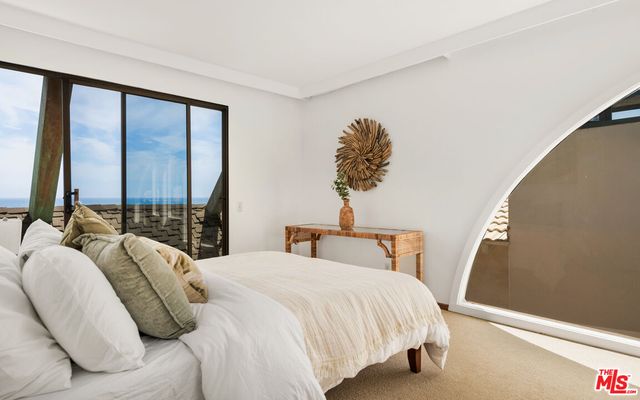 a view of a chairs and table in the balcony