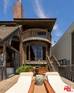 a backyard of a house with flower plants
