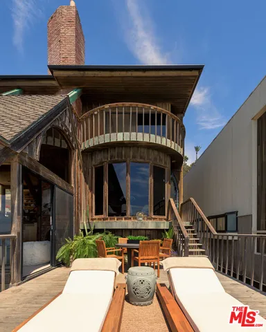a backyard of a house with flower plants