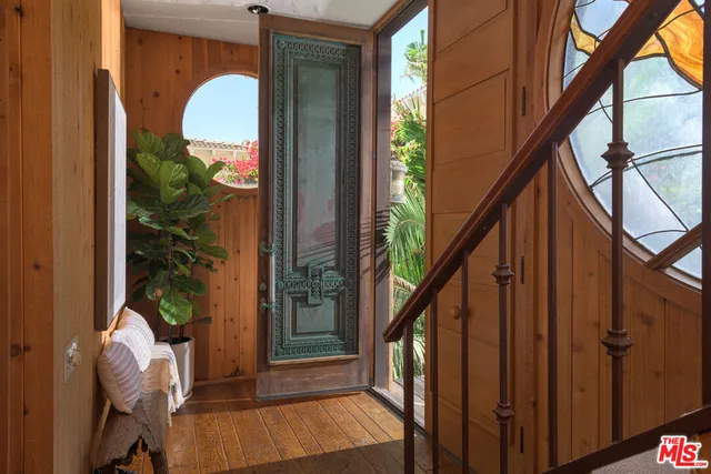 a view of living room kitchen and entryway