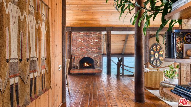 a dining room with wooden floor table and chairs