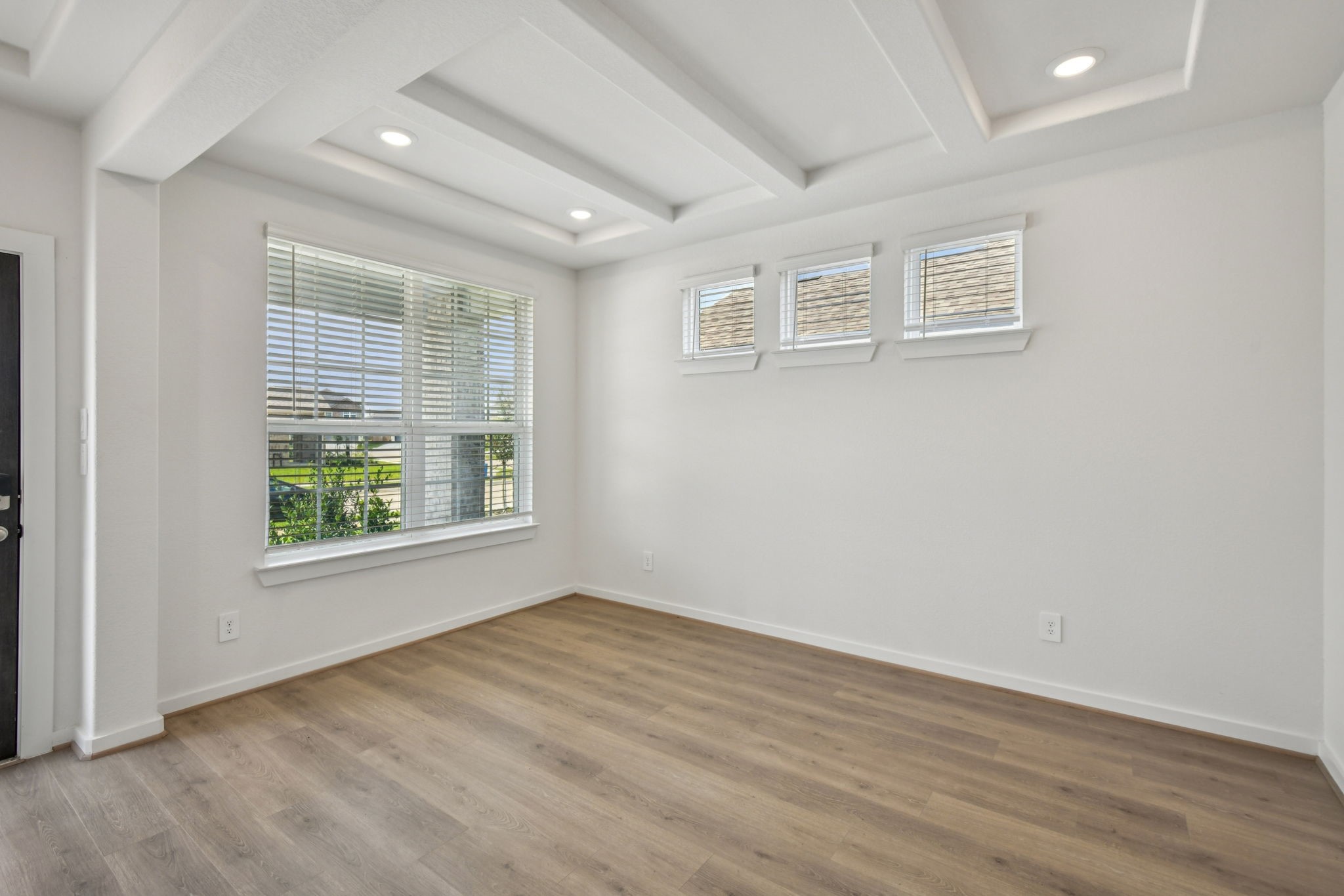 6631 Castella Drive Rosharon, TX 77583 - Photo 6 of 47 an empty room with wooden floor and windows