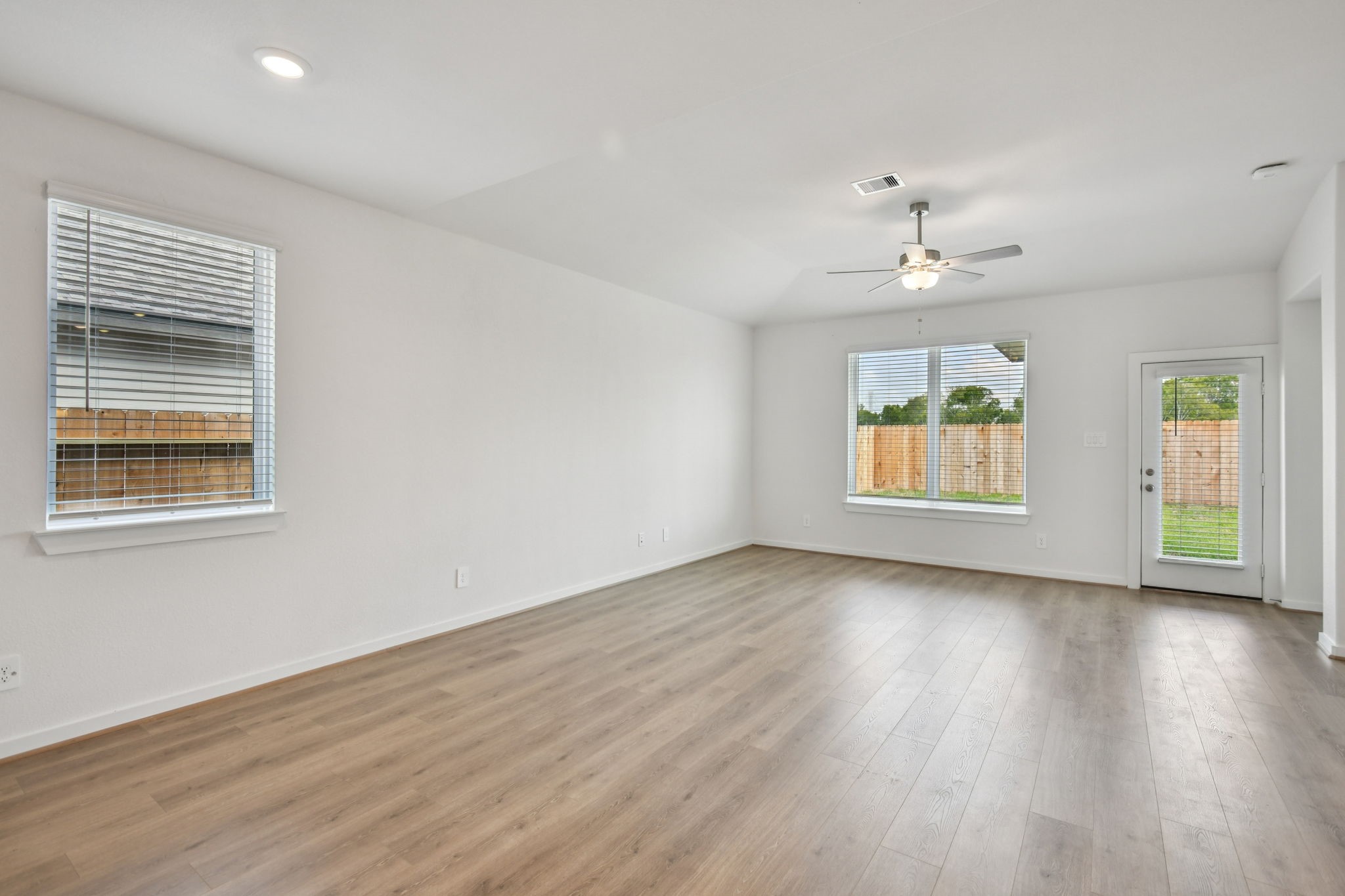 6631 Castella Drive Rosharon, TX 77583 - Photo 7 of 47 an empty room with wooden floor chandelier and windows