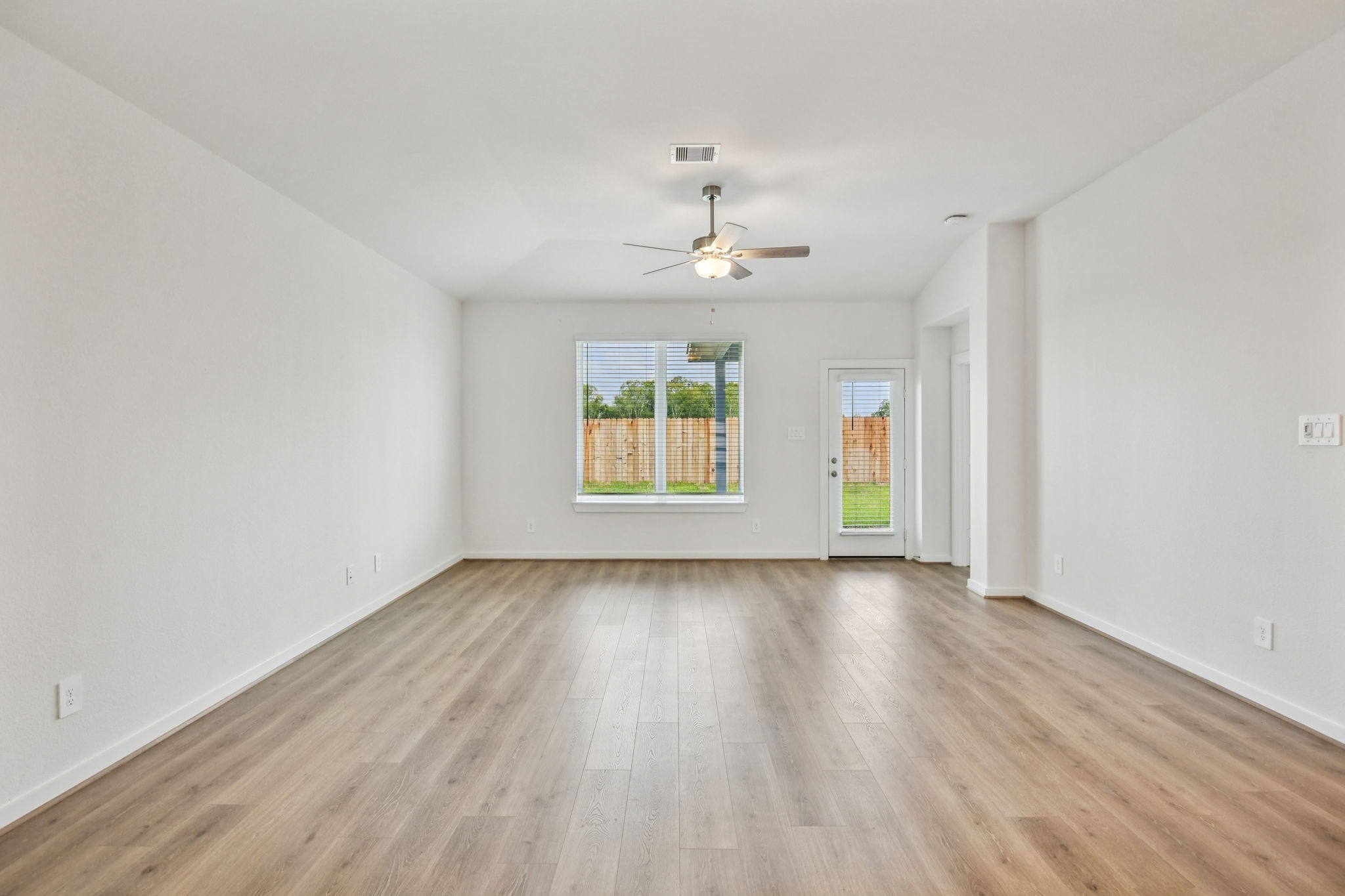6631 Castella Drive Rosharon, TX 77583 - Photo 8 of 47 an empty room with wooden floor chandelier and windows