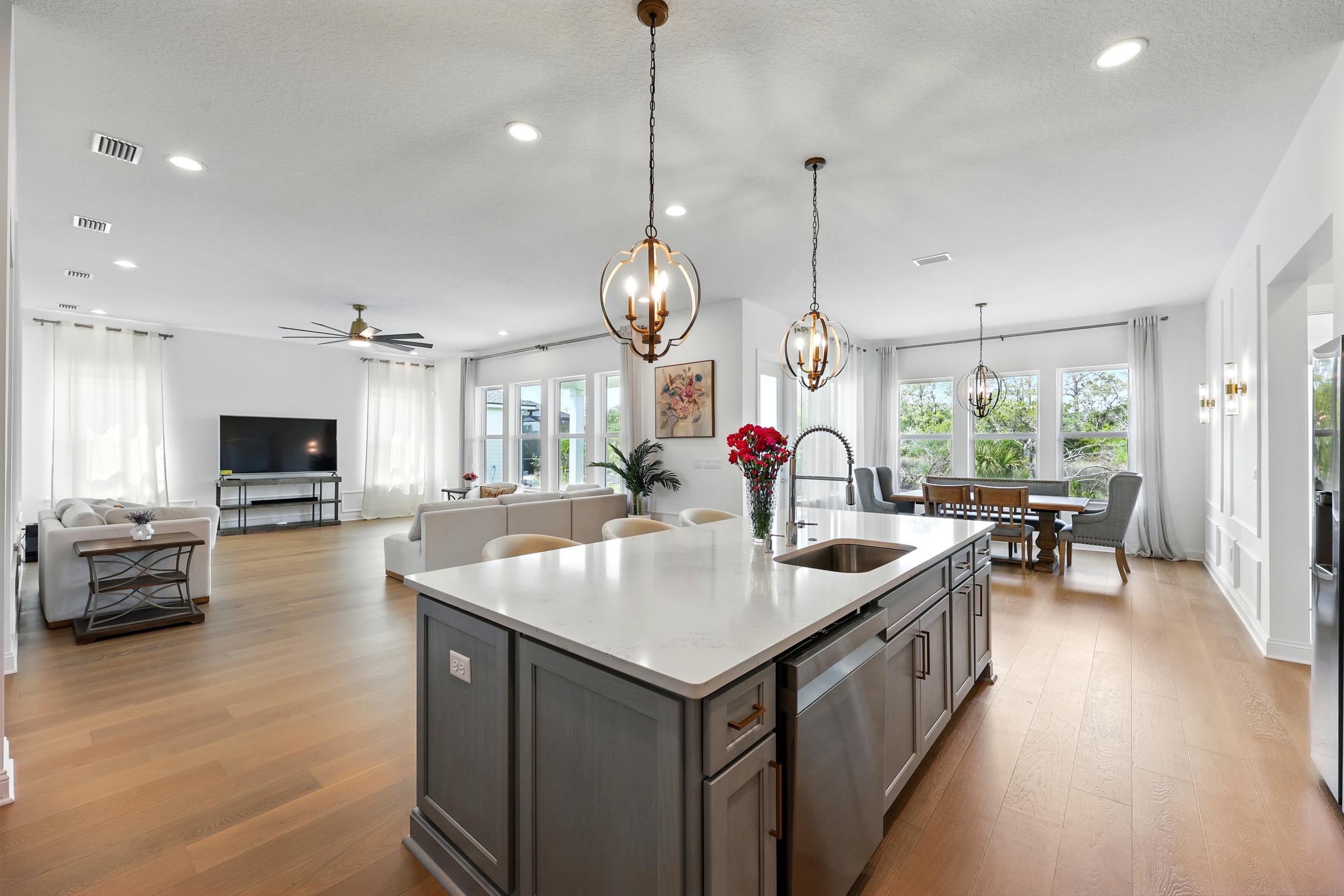 164 Tesoro Terrace St. Augustine, FL 32095 - Photo 14 of 55 a open kitchen with stainless steel appliances granite countertop a sink a stove and a dining table with wooden floor