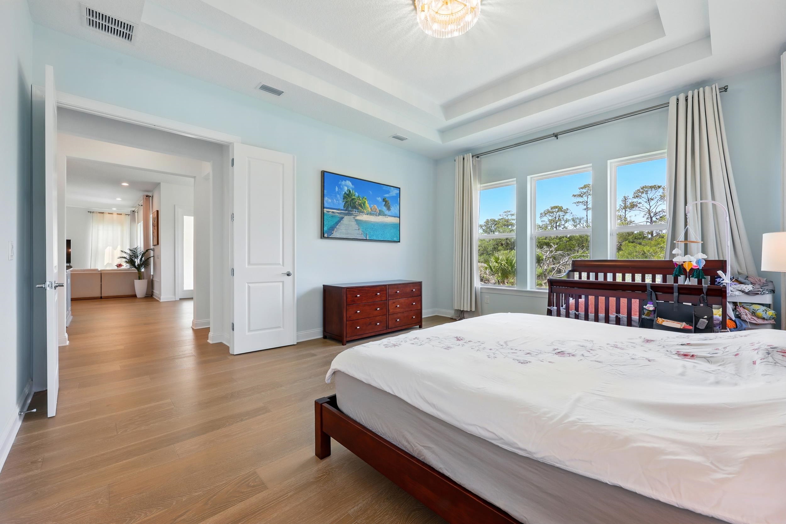 164 Tesoro Terrace St. Augustine, FL 32095 - Photo 22 of 55 a bedroom with a large bed and a large window