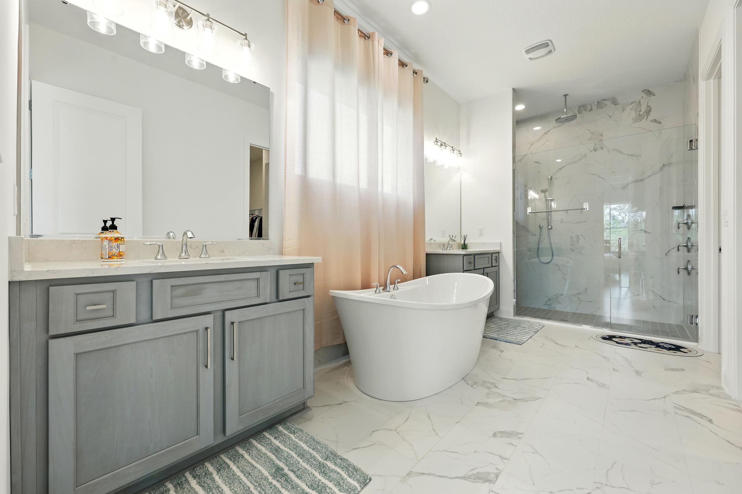 164 Tesoro Terrace St. Augustine, FL 32095 - Photo 23 of 55 a bathroom with a sink a toilet a mirror and shower