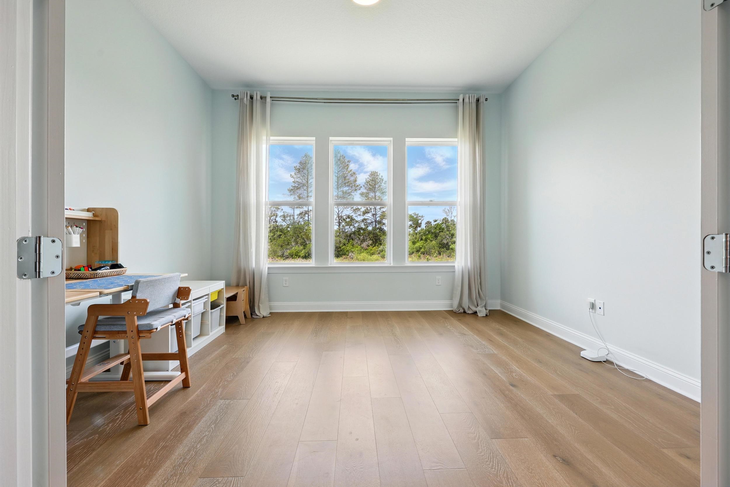 164 Tesoro Terrace St. Augustine, FL 32095 - Photo 27 of 55 an empty room with wooden floor and windows