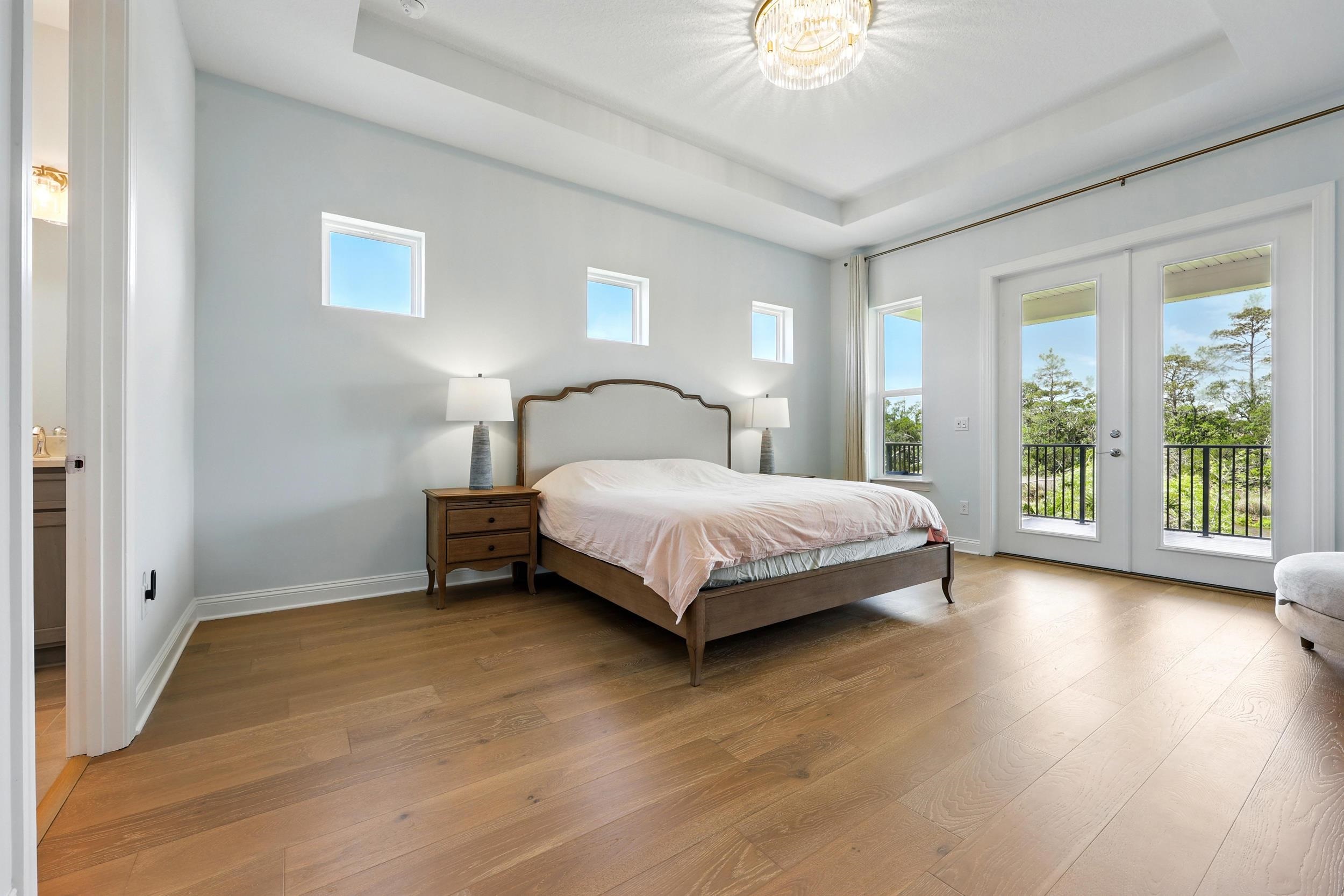 164 Tesoro Terrace St. Augustine, FL 32095 - Photo 29 of 55 a bedroom with a bed and a chandelier