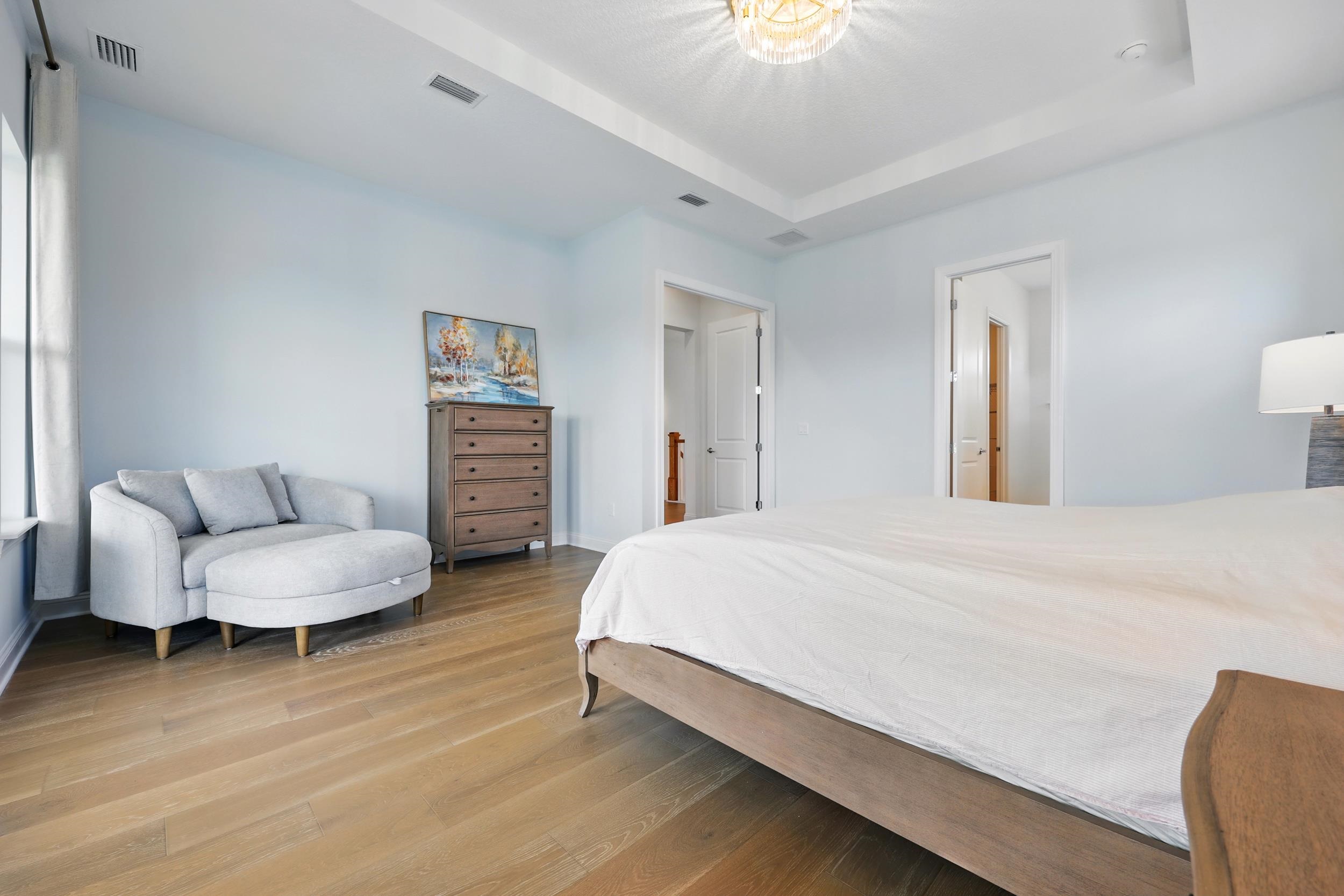 164 Tesoro Terrace St. Augustine, FL 32095 - Photo 30 of 55 a spacious bedroom with a bed and a couch