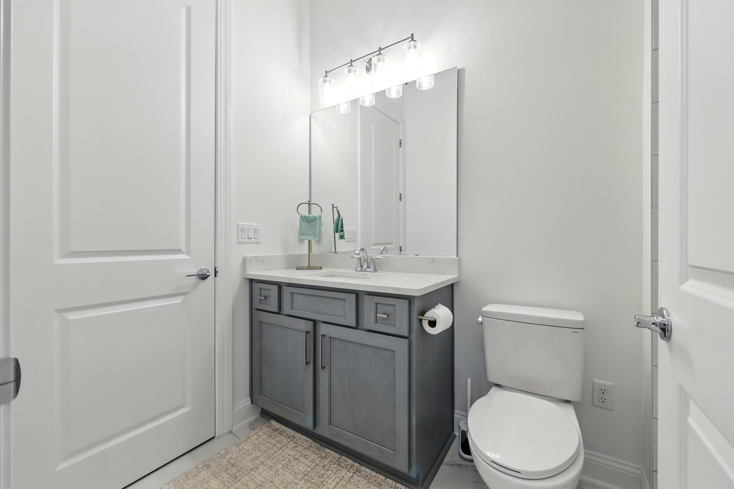 164 Tesoro Terrace St. Augustine, FL 32095 - Photo 34 of 55 a bathroom with a toilet a sink a vanity and mirror