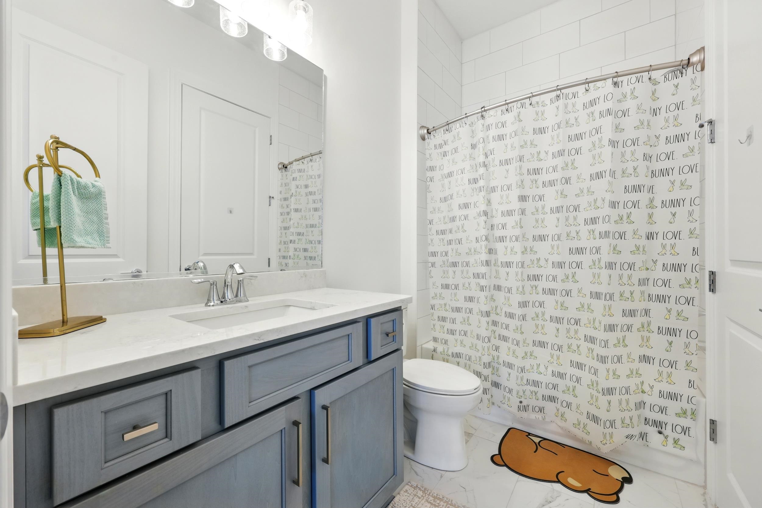 164 Tesoro Terrace St. Augustine, FL 32095 - Photo 36 of 55 a bathroom with a granite countertop toilet a sink a mirror and a shower