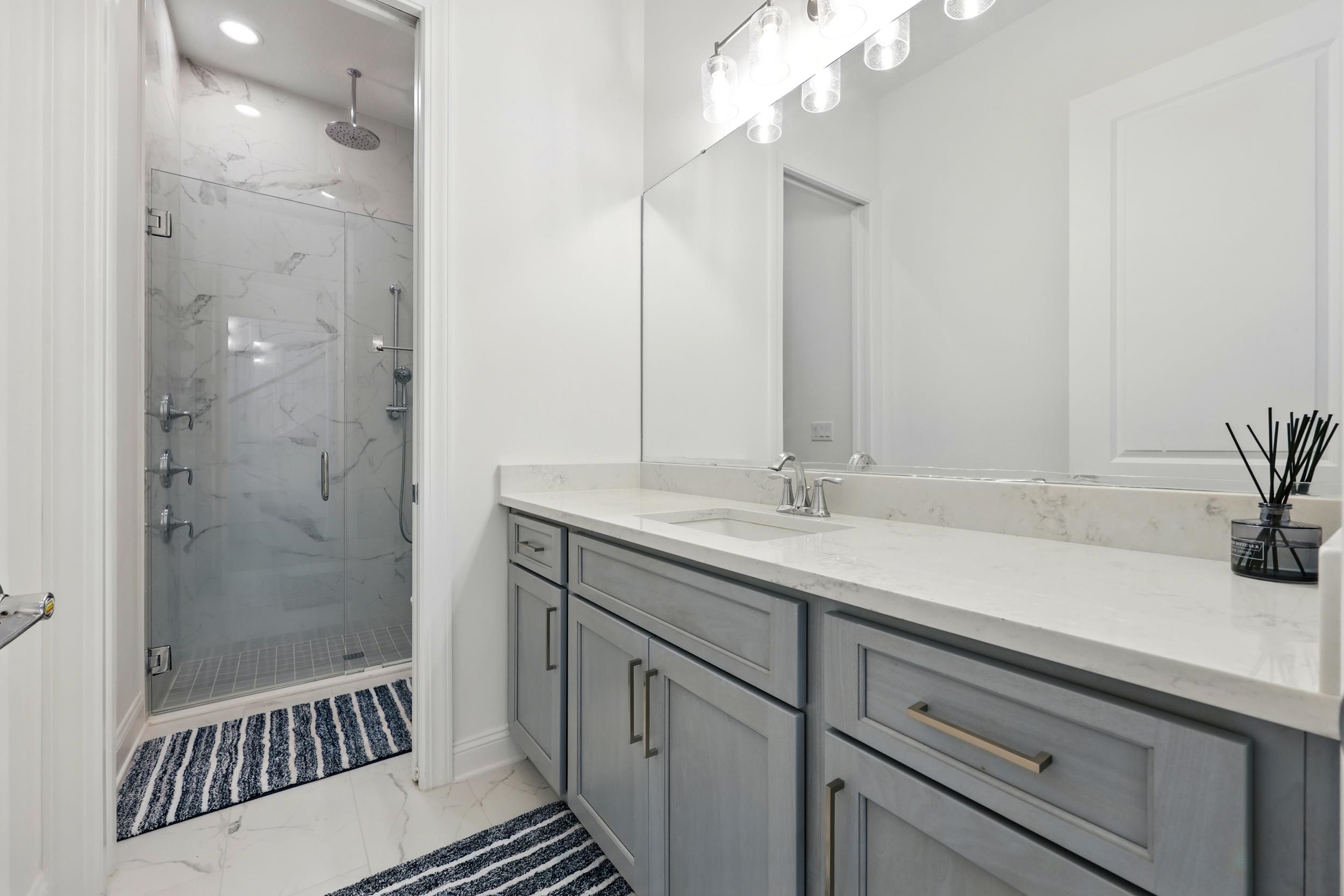 164 Tesoro Terrace St. Augustine, FL 32095 - Photo 7 of 55 a bathroom with a sink a large mirror and shower