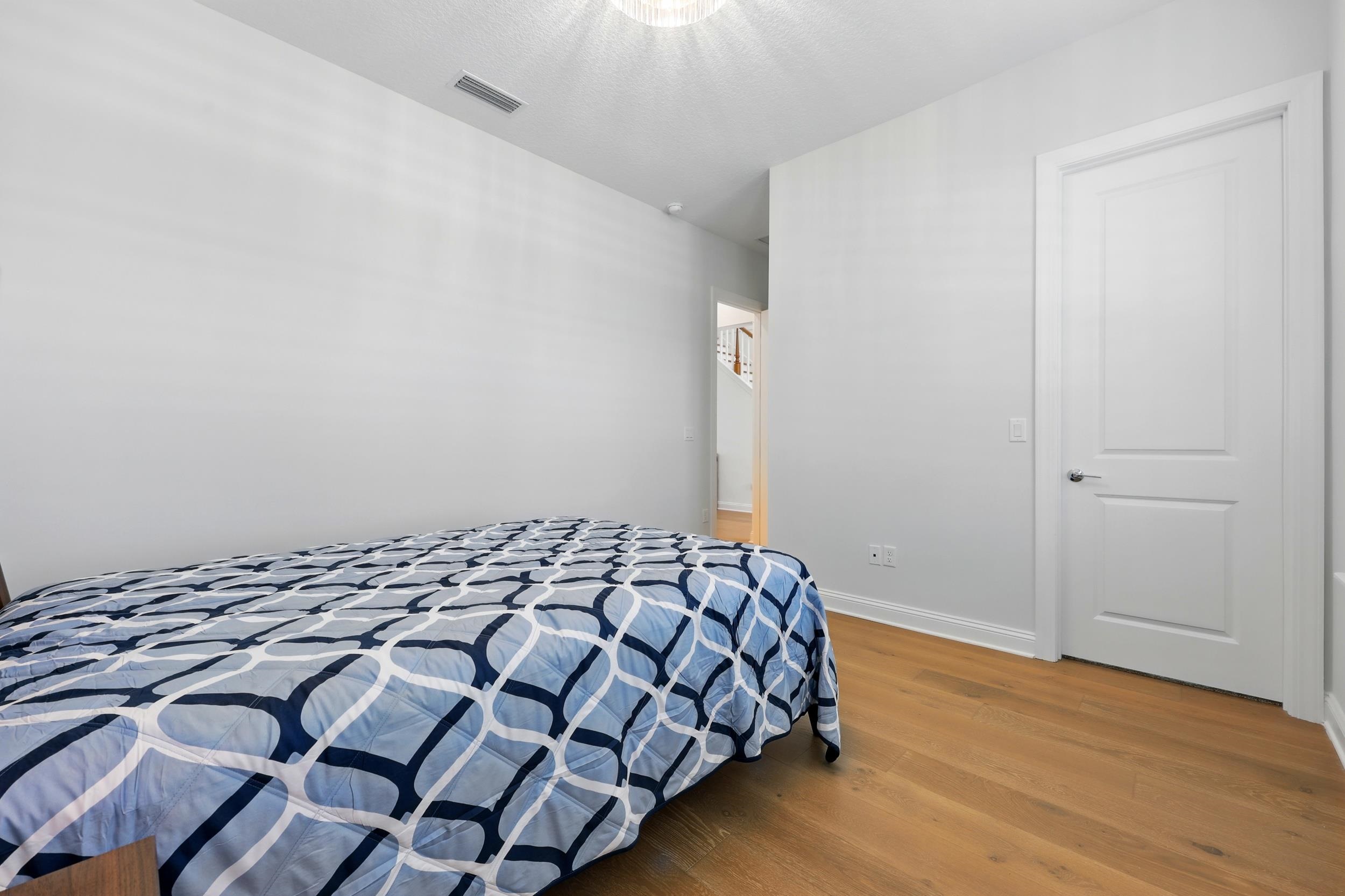 164 Tesoro Terrace St. Augustine, FL 32095 - Photo 9 of 55 a bedroom with a bed and wooden floor