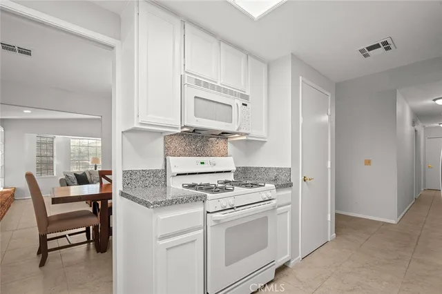 a kitchen with cabinets appliances and a window