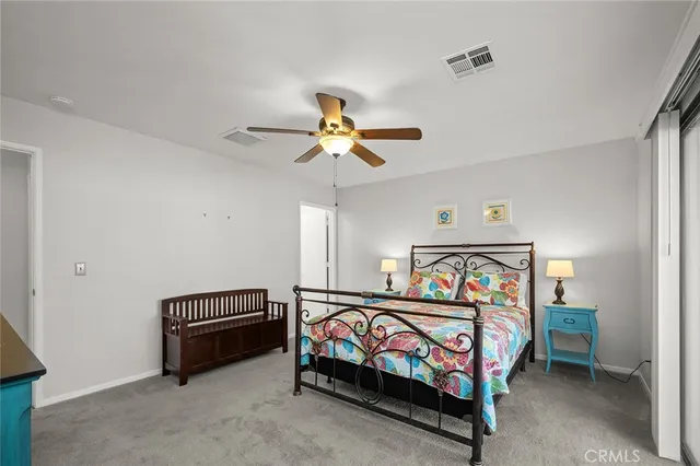 a bedroom with furniture and a ceiling fan