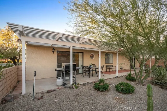 a view of backyard with patio