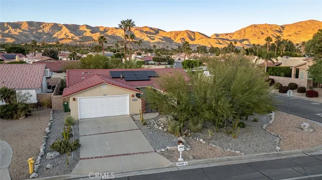 an aerial view of a house with a swimming pool