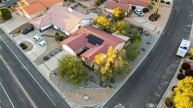 an aerial view of a house with a yard and garden