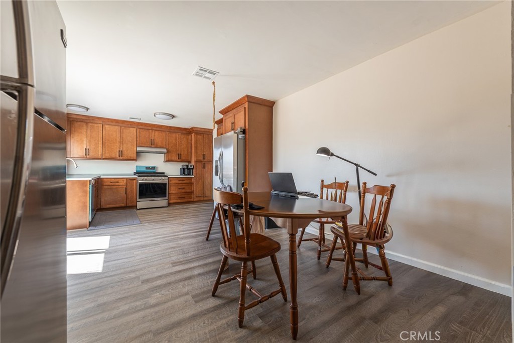 6732 San Joaquin Way Riverside, CA 92503 - Photo 13 of 25 a view of a kitchen with dining table and chairs