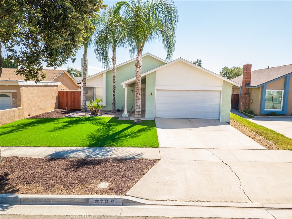 6732 San Joaquin Way Riverside, CA 92503 - Photo 22 of 25 a front view of a house with a yard and garage