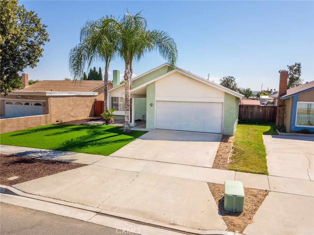 6732 San Joaquin Way Riverside, CA 92503 - Photo 23 of 25 a front view of a house with a garden and palm trees
