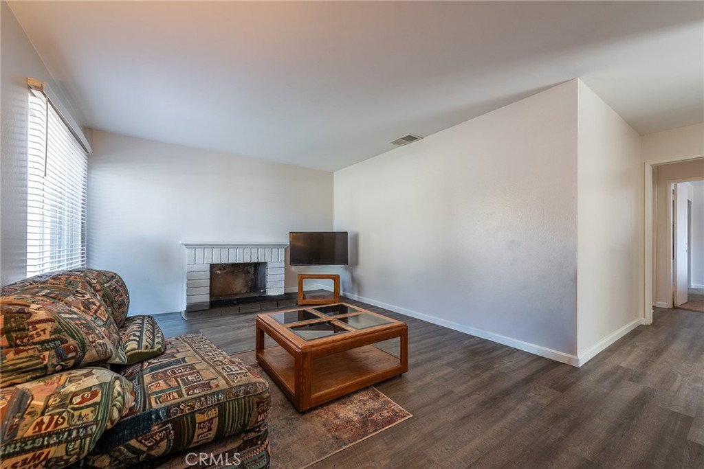 6732 San Joaquin Way Riverside, CA 92503 - Photo 3 of 25 a living room with furniture and a fireplace