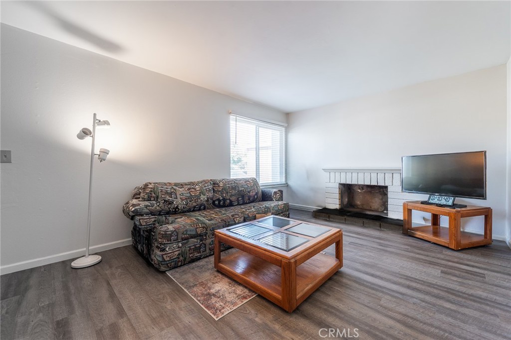 6732 San Joaquin Way Riverside, CA 92503 - Photo 4 of 25 a living room with furniture a flat screen tv and a fireplace