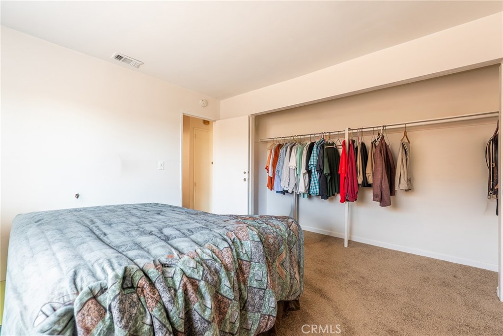 6732 San Joaquin Way Riverside, CA 92503 - Photo 8 of 25 a bed room with a bed and a walk in closet