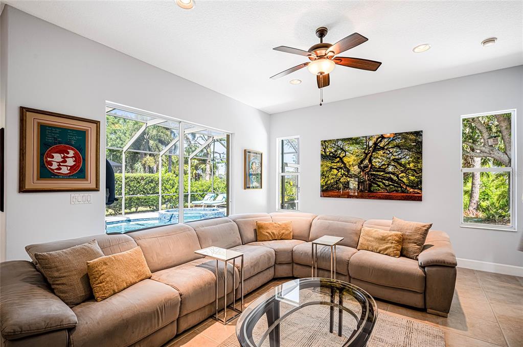 956 Scherer Way Osprey, FL 34229 - Photo 11 of 38 a living room with furniture ceiling fan and a window