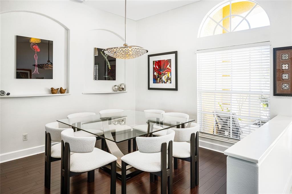 956 Scherer Way Osprey, FL 34229 - Photo 12 of 38 a view of a dining room with furniture and wooden floor