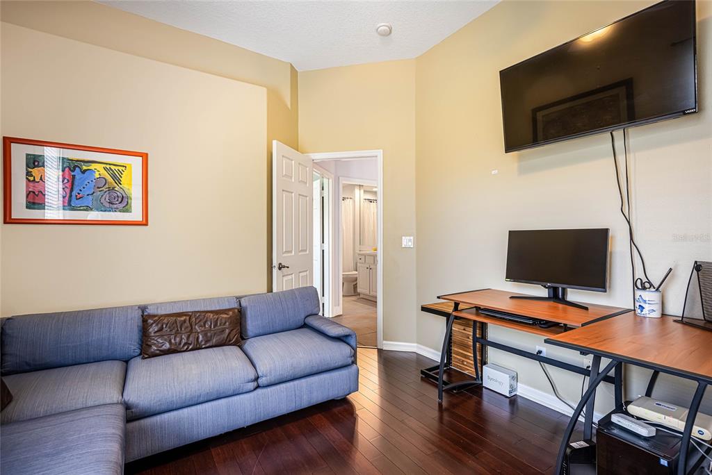 956 Scherer Way Osprey, FL 34229 - Photo 21 of 38 a living room with furniture and a flat screen tv