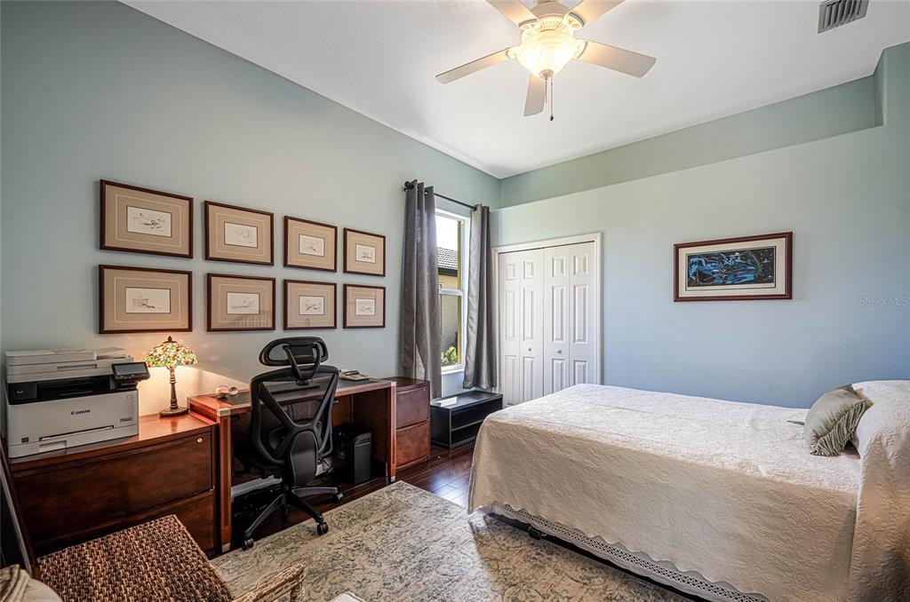 956 Scherer Way Osprey, FL 34229 - Photo 23 of 38 a bedroom that has a bed and a chandelier