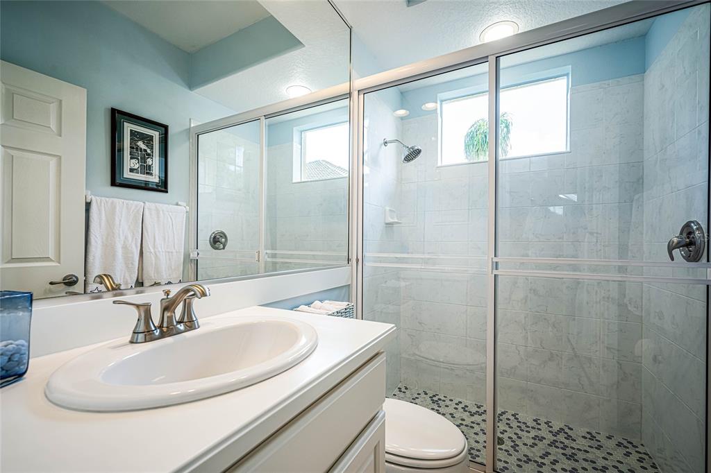 956 Scherer Way Osprey, FL 34229 - Photo 24 of 38 a bathroom with a sink toilet and shower