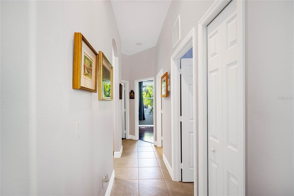 956 Scherer Way Osprey, FL 34229 - Photo 25 of 38 a view of a hallway with paintings on the wall