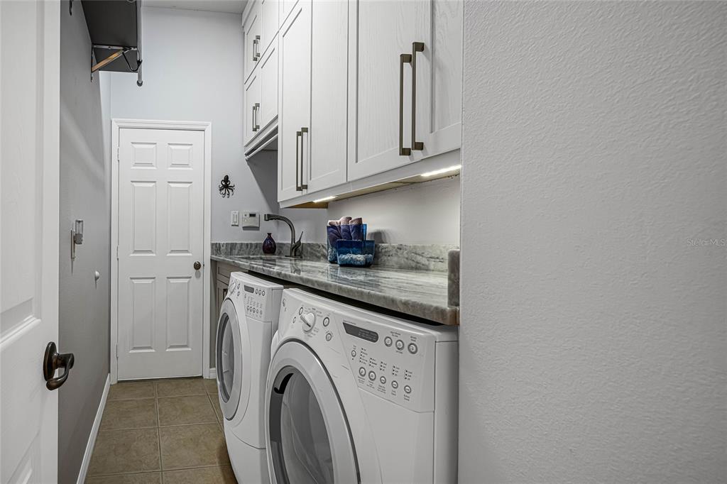956 Scherer Way Osprey, FL 34229 - Photo 26 of 38 a view of a storage and utility room with washer and dryer