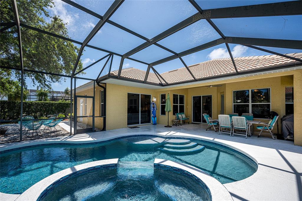 956 Scherer Way Osprey, FL 34229 - Photo 27 of 38 a view of a house with backyard sitting area and porch