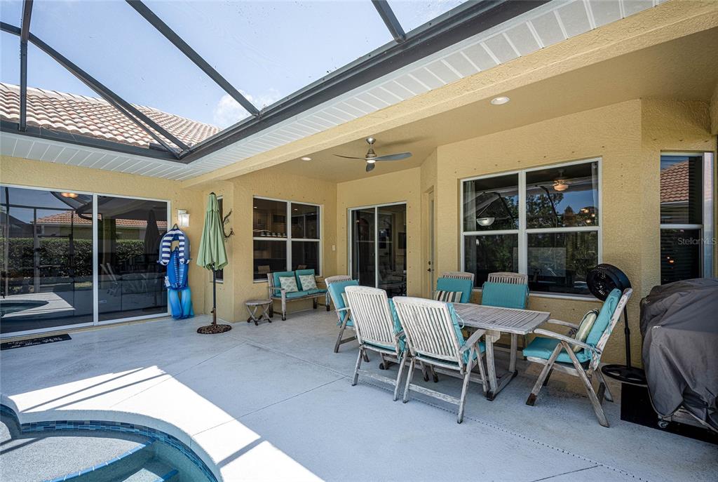 956 Scherer Way Osprey, FL 34229 - Photo 29 of 38 a view of a patio with table and chairs and potted plants