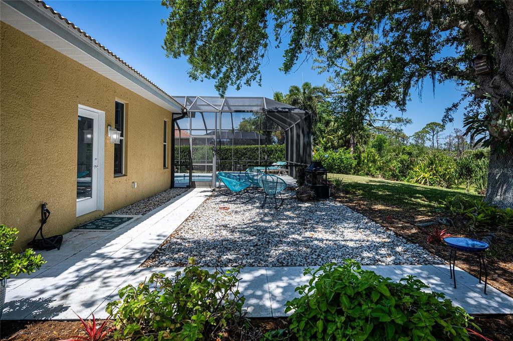 956 Scherer Way Osprey, FL 34229 - Photo 30 of 38 a view of a backyard with plants and large trees