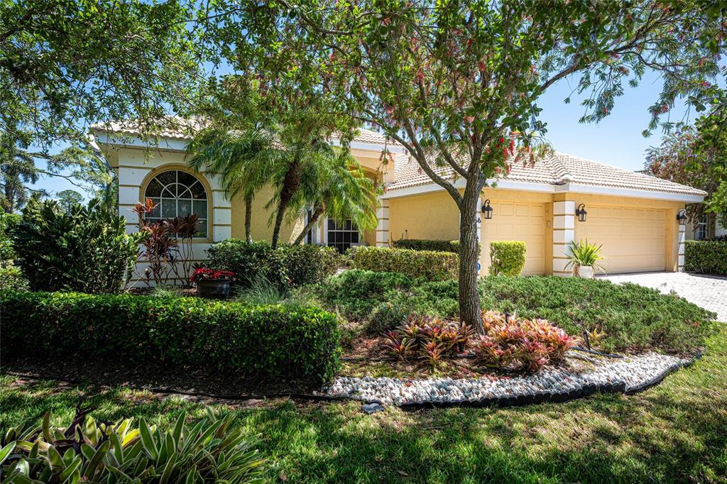 956 Scherer Way Osprey, FL 34229 - Photo 32 of 38 a front view of a house with garden